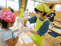 （写真）作り方や食材の切り方を教えます。